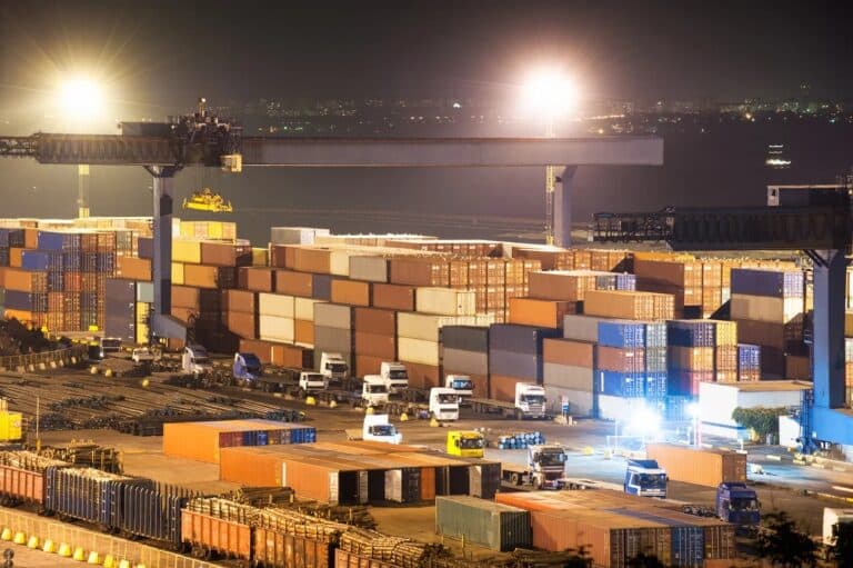 Dock congestion with trucks at a loading bay monitored through logistics video analytics to optimize turnaround time.