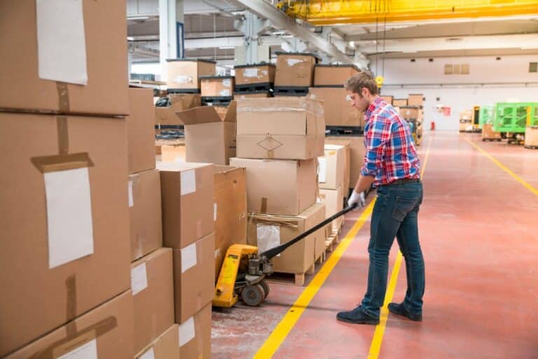 Fatigued warehouse worker showing signs of error while handling equipment, monitored through logistics video analytics for safety and efficiency.
